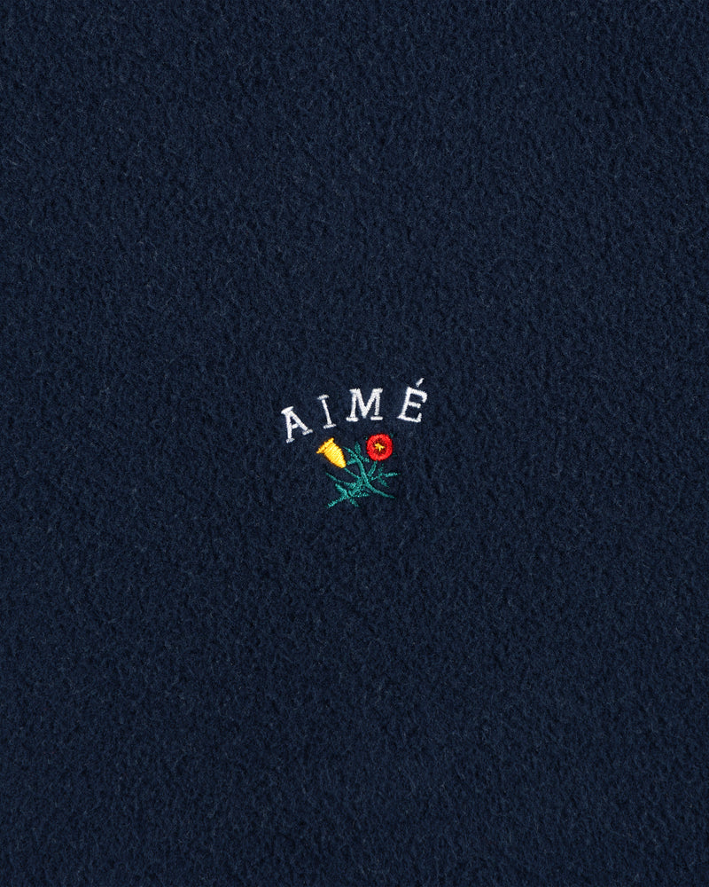 Navy Crest Fleece Casual Jacket with AIMÉ embroidered above a yellow and red flower on the center.