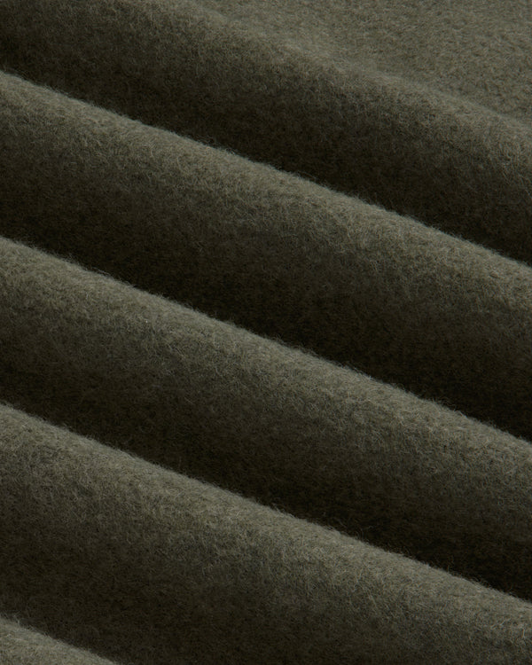 Close-up of olive green Surplus Fleece Quarter Zip Pullover fabric with soft, diagonal folds.