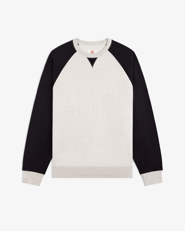 ALD / Olympiacos F.C. Colorblock Crewneck Sweatshirt in off-white with black raglan sleeves and ribbed trim.