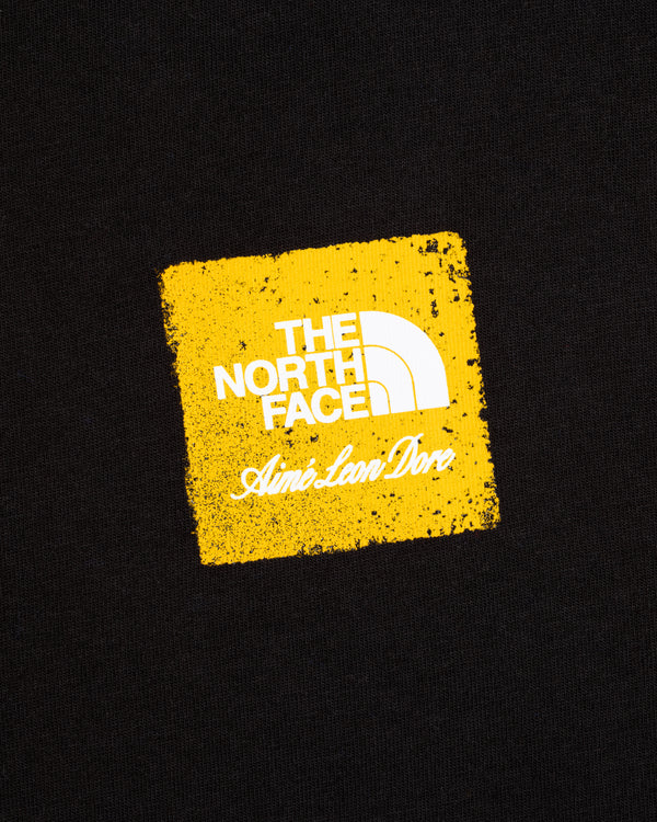 ALD / The North Face Logo Tee: Yellow square with both logos on a black background.
