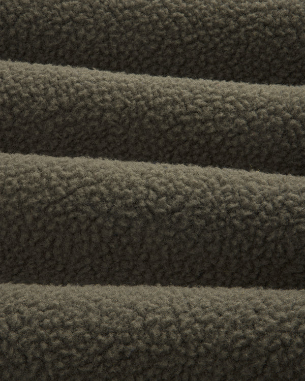 Close-up of ALD / The North Face Fleece Rugby, showing its soft, textured dark brown fleece in horizontal folds.