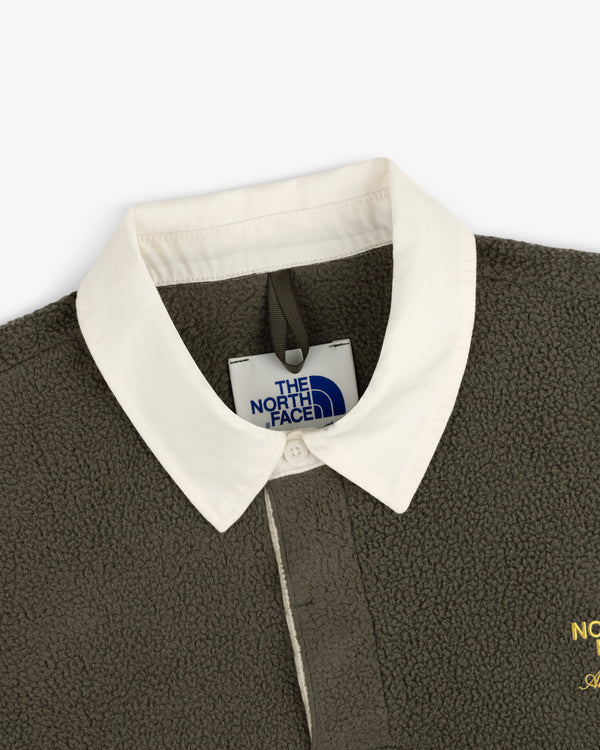 Close-up of the ALD / The North Face Fleece Rugby, featuring a white collar and interior brand tag.