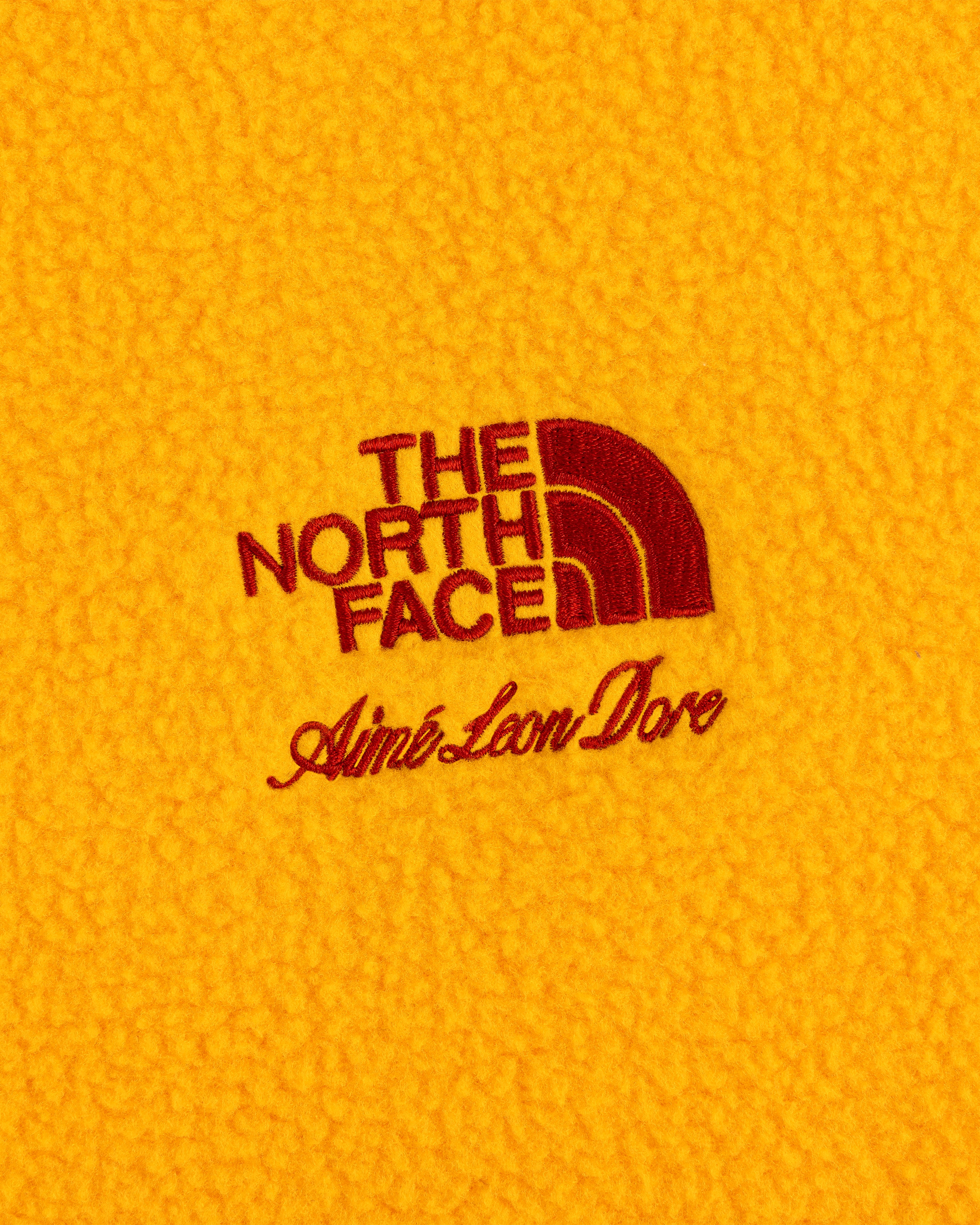 ALD / The North Face Fleece Rugby in yellow with red embroidered logos on the fabric.