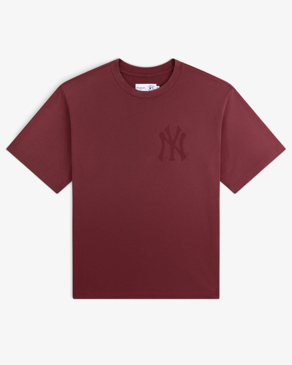 Yankees Washed Logo Tee: Maroon short-sleeve shirt featuring a subtle NY Yankees logo on the left chest.