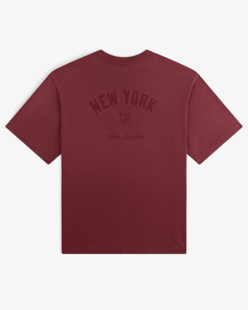 Yankees Washed Logo Tee: Maroon t-shirt with NEW YORK and Aimé Leon Dore text in dark print on back.