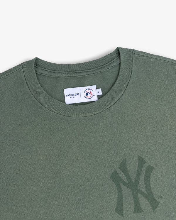 Yankees Washed Logo Tee in green with a subtle Yankees logo and visible neck tag inside the collar.