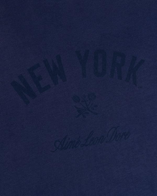 Yankees Washed Logo Tee in navy with NEW YORK, Aimé Leon Dore text, and a small dark floral graphic.