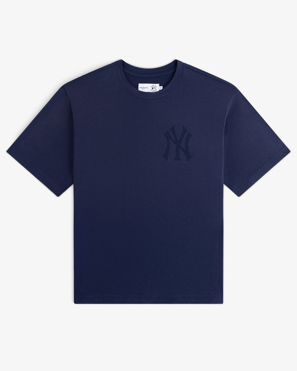 Yankees Washed Logo Tee: navy blue short-sleeve shirt with a dark NY Yankees logo on the left chest.