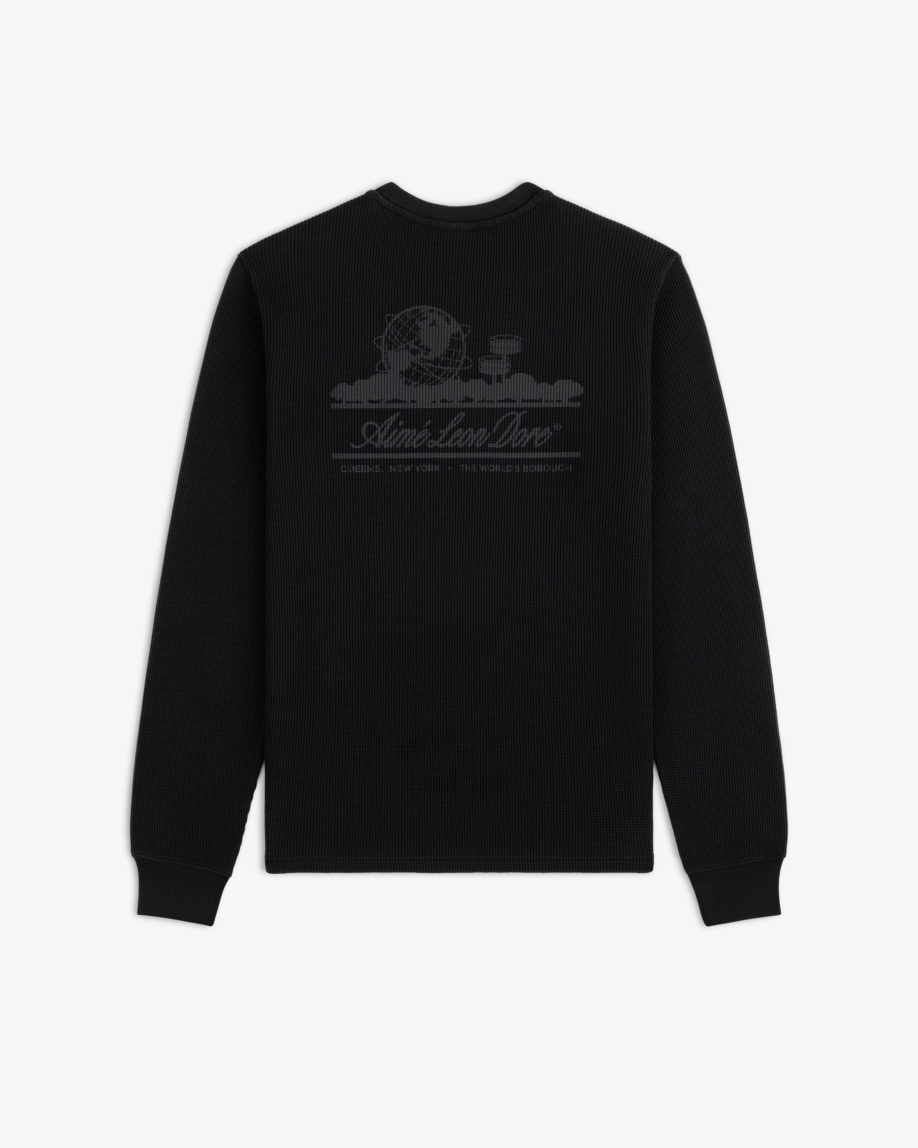Long-Sleeve Unisphere Waffle Thermal in black with globe graphic and text on upper back, shown on white background.