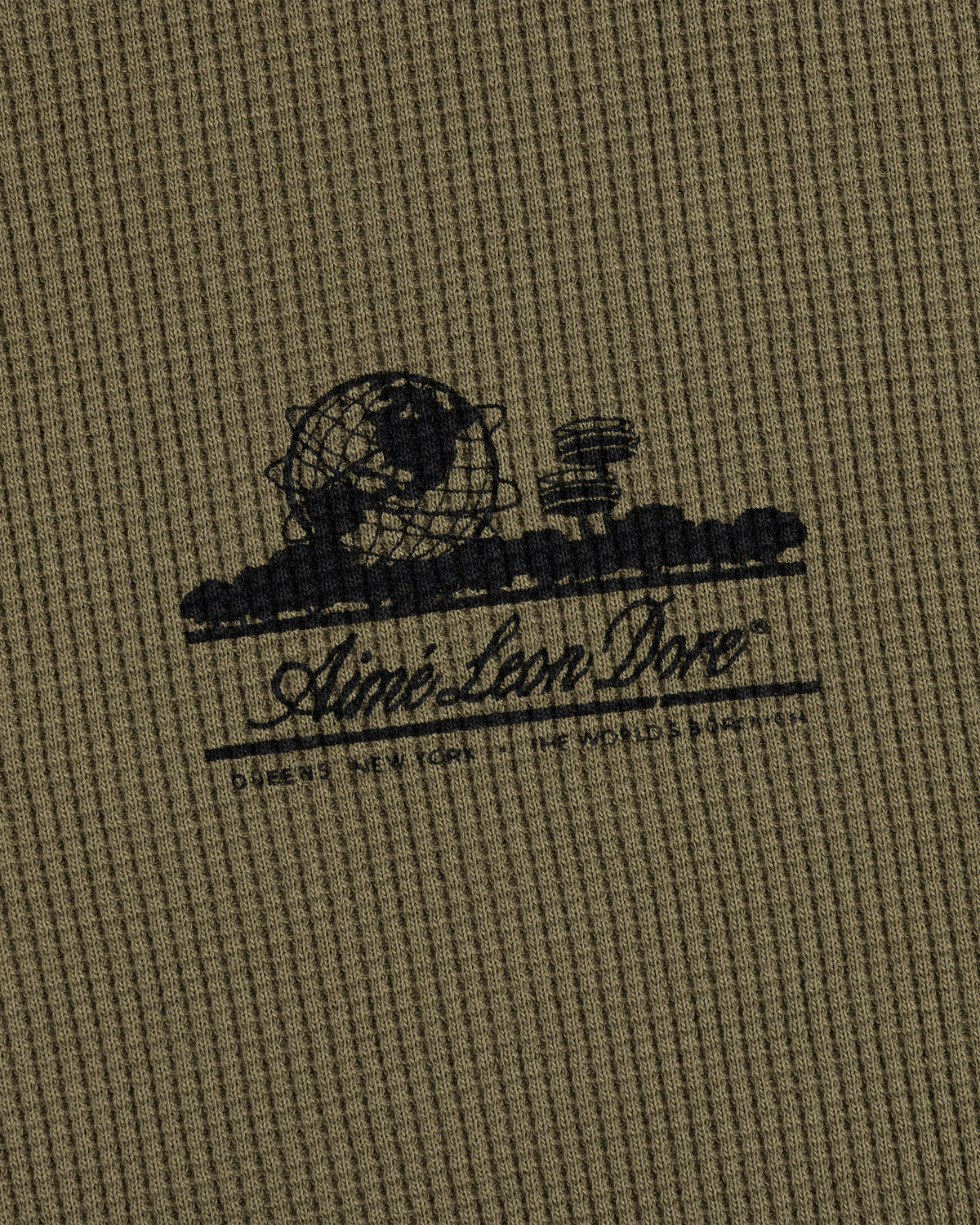Olive Long-Sleeve Unisphere Waffle Thermal with a black globe, landscape print, and Ainé bon Doré cursive text.