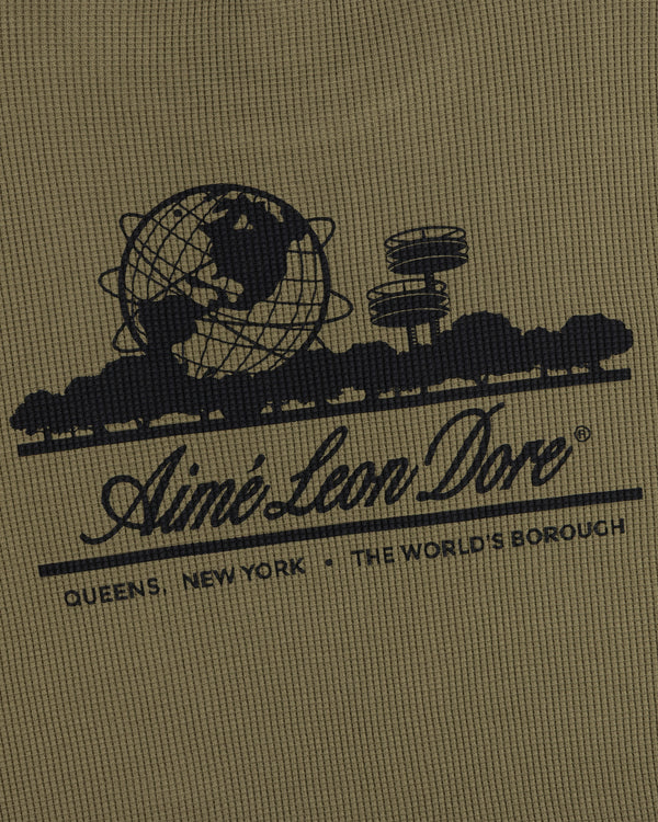 Black globe and building graphic with text on khaki Long-Sleeve Unisphere Waffle Thermal by Aimé Leon Dore.