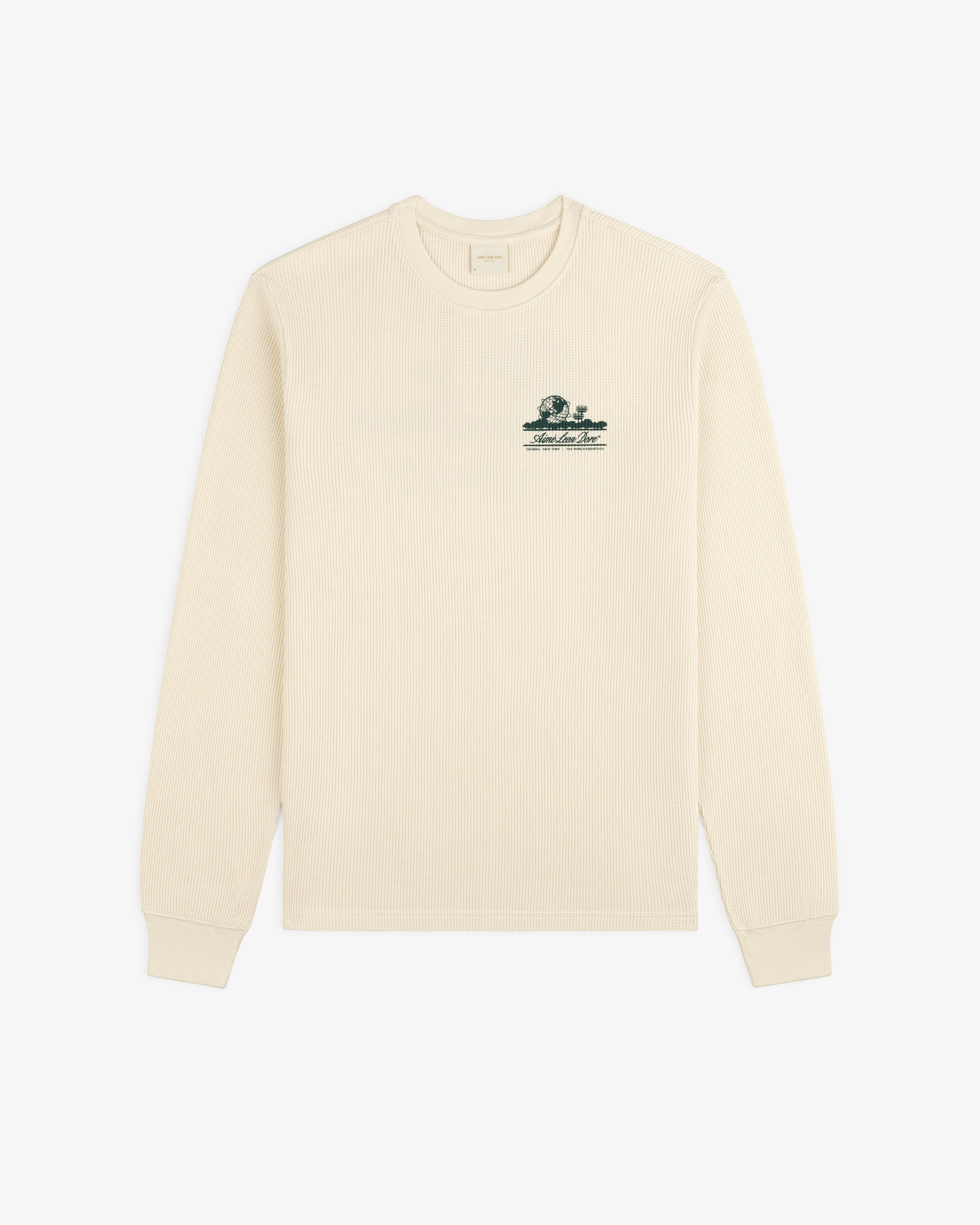 Cream Unisphere Waffle Thermal, long sleeves, ribbed texture, small green logo embroidered on left chest.