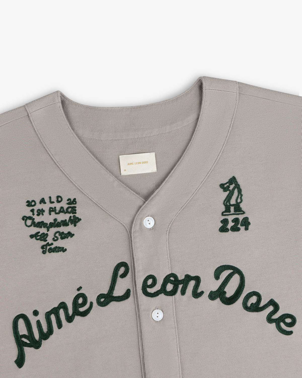 Mulberry Chainstitch Baseball Jersey in gray with dark green script and embroidered chest text and graphics.