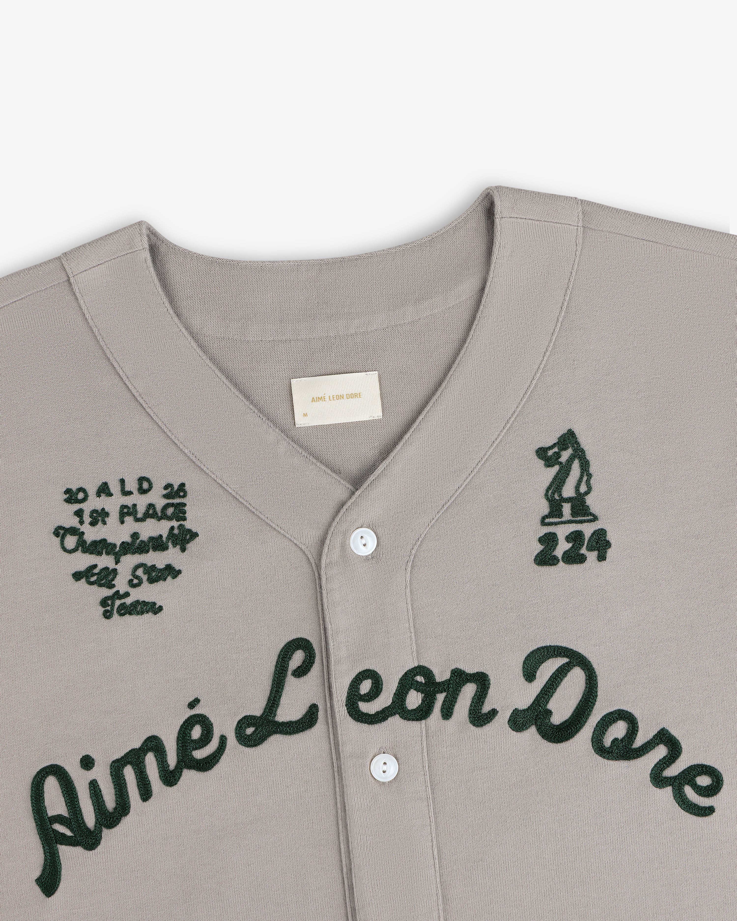 Mulberry Chainstitch Baseball Jersey in gray with dark green script and embroidered chest text and graphics.