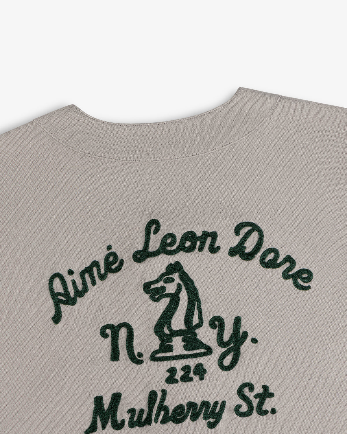 Beige Mulberry Chainstitch Baseball Jersey with green Aimé Leon Dore text, N.Y., 224 Mulberry, and chess knight.