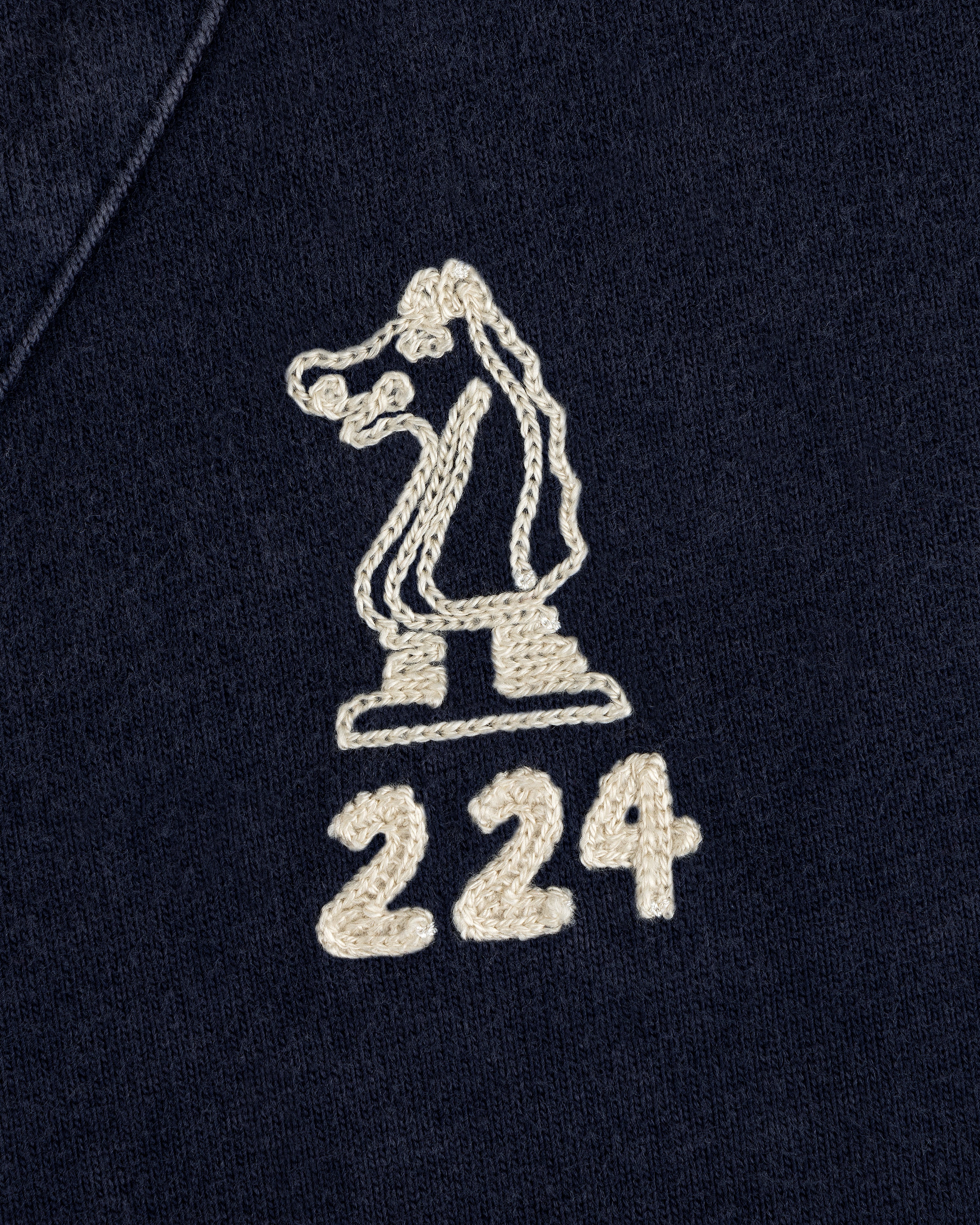 Mulberry Chainstitch Baseball Jersey: white chess knight & “224” embroidered on dark fabric, close-up view.