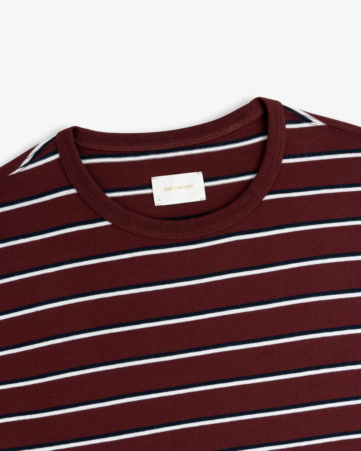Yarn Dyed Striped Tee in burgundy with white and navy stripes, neck to upper chest view on white background.