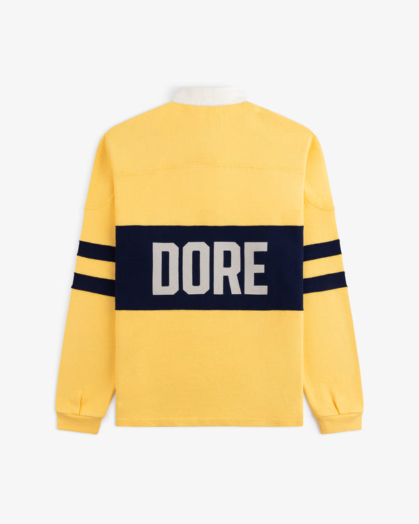 Leon Dore Collegiate Rugby: yellow long-sleeve with navy stripes, “DORE” in white on a navy back rectangle.