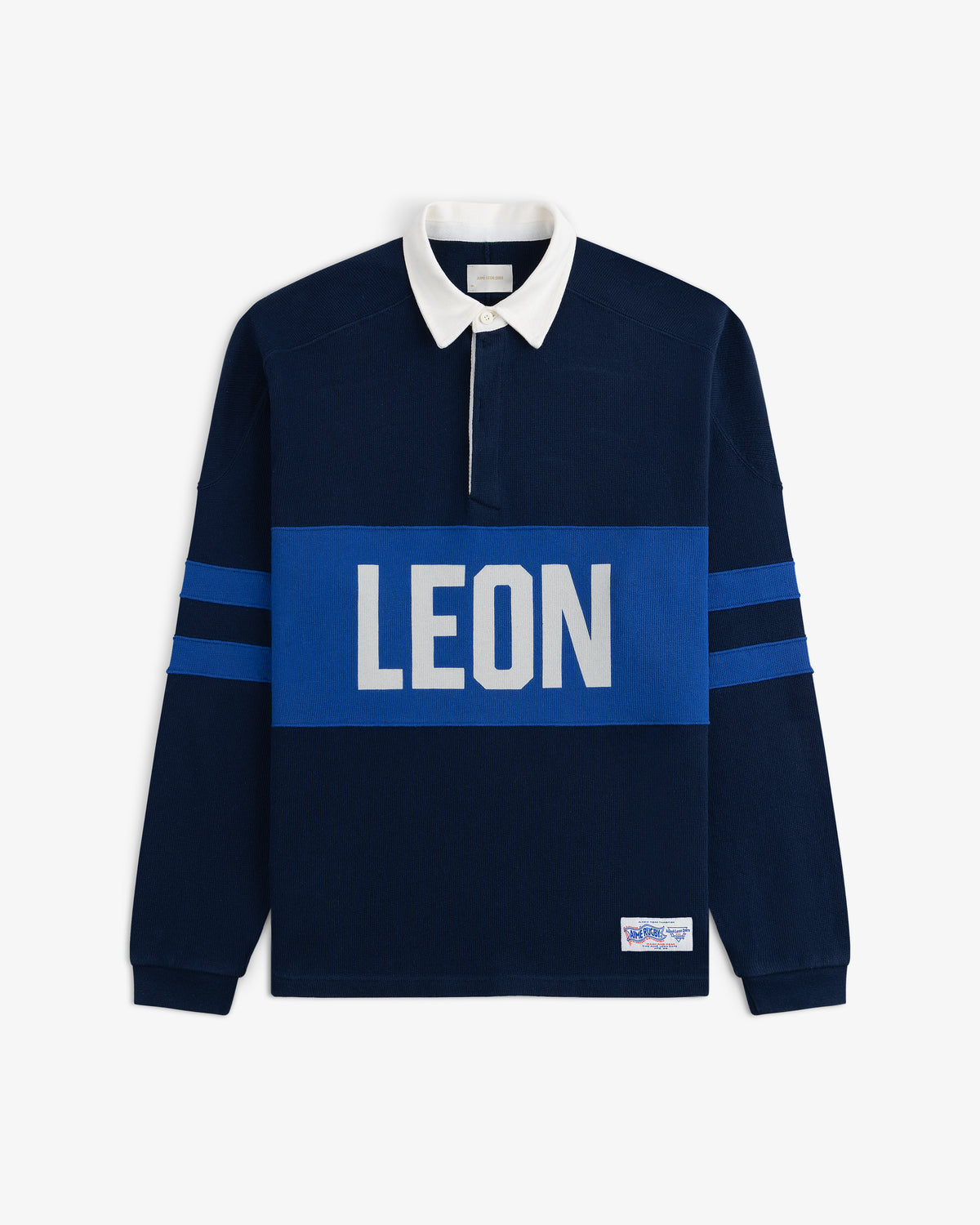 Leon Dore Collegiate Rugby: navy shirt, white collar, blue sleeve stripes, bold LEON logo across the chest.