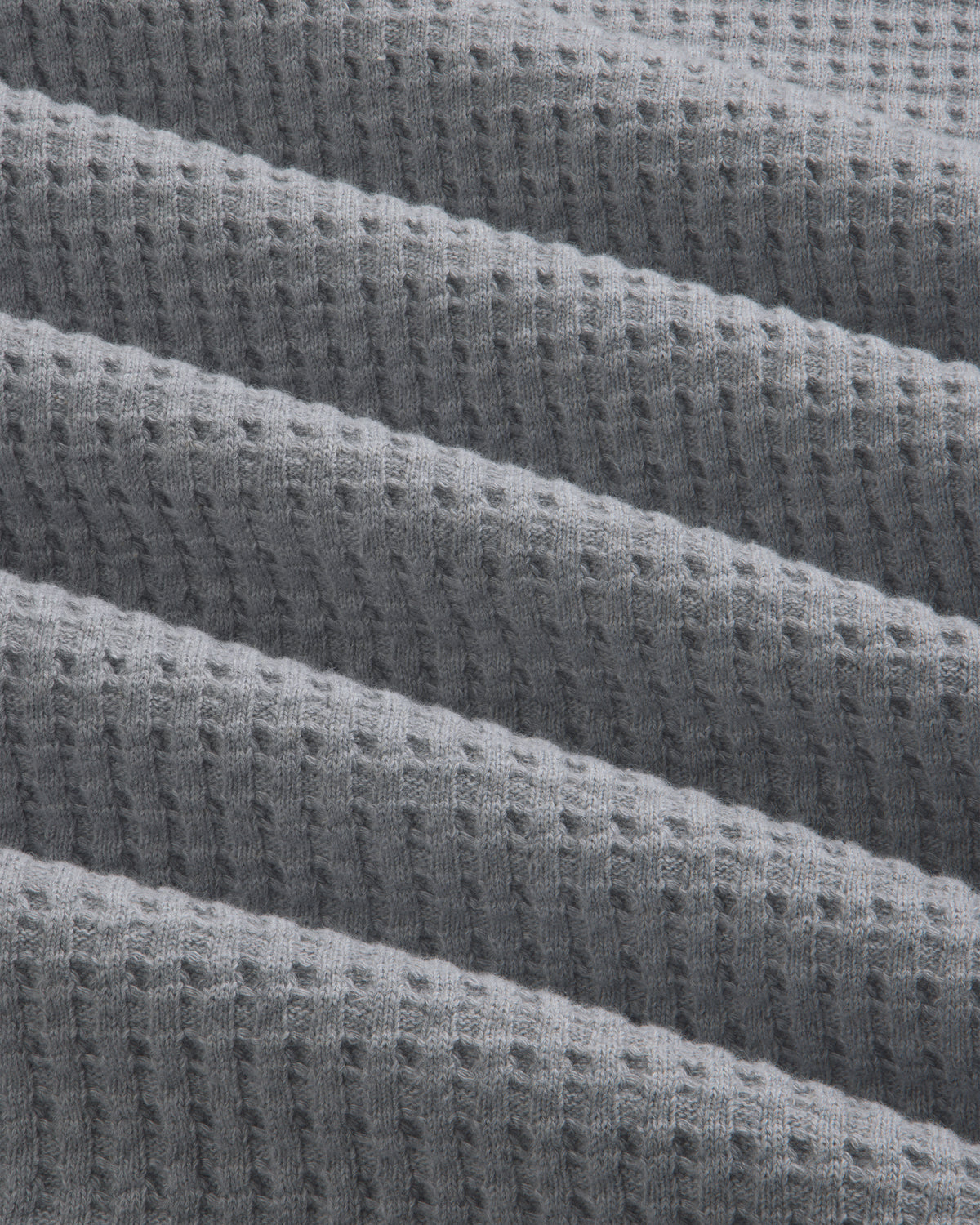 Close-up of gray Long-Sleeve Waffle Thermal fabric with a textured waffle knit pattern.