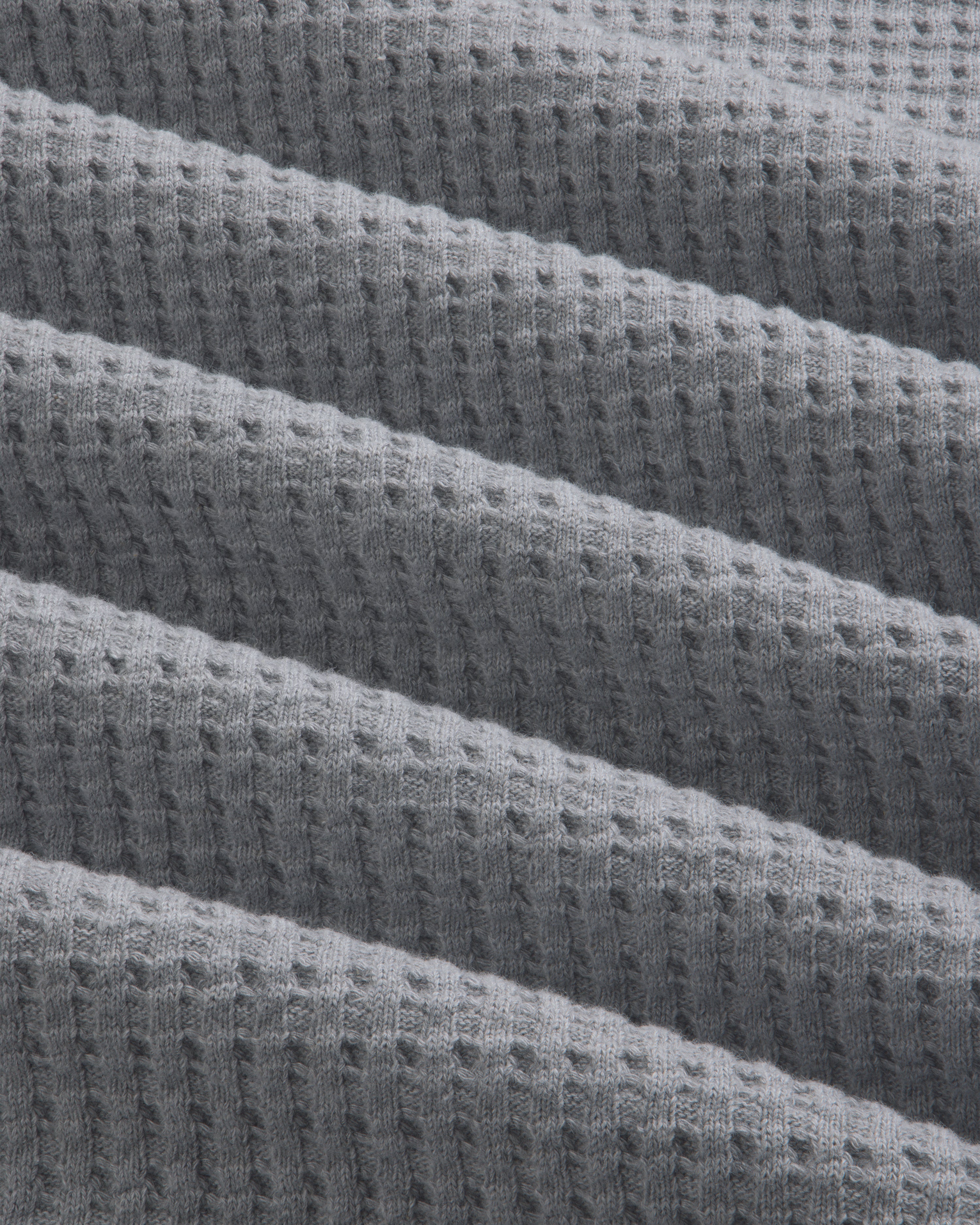 Close-up of gray Long-Sleeve Waffle Thermal fabric with a textured waffle knit pattern.