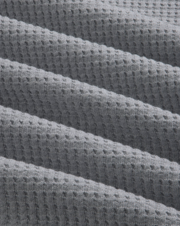 Close-up of gray Long-Sleeve Waffle Thermal fabric with a textured waffle knit pattern.