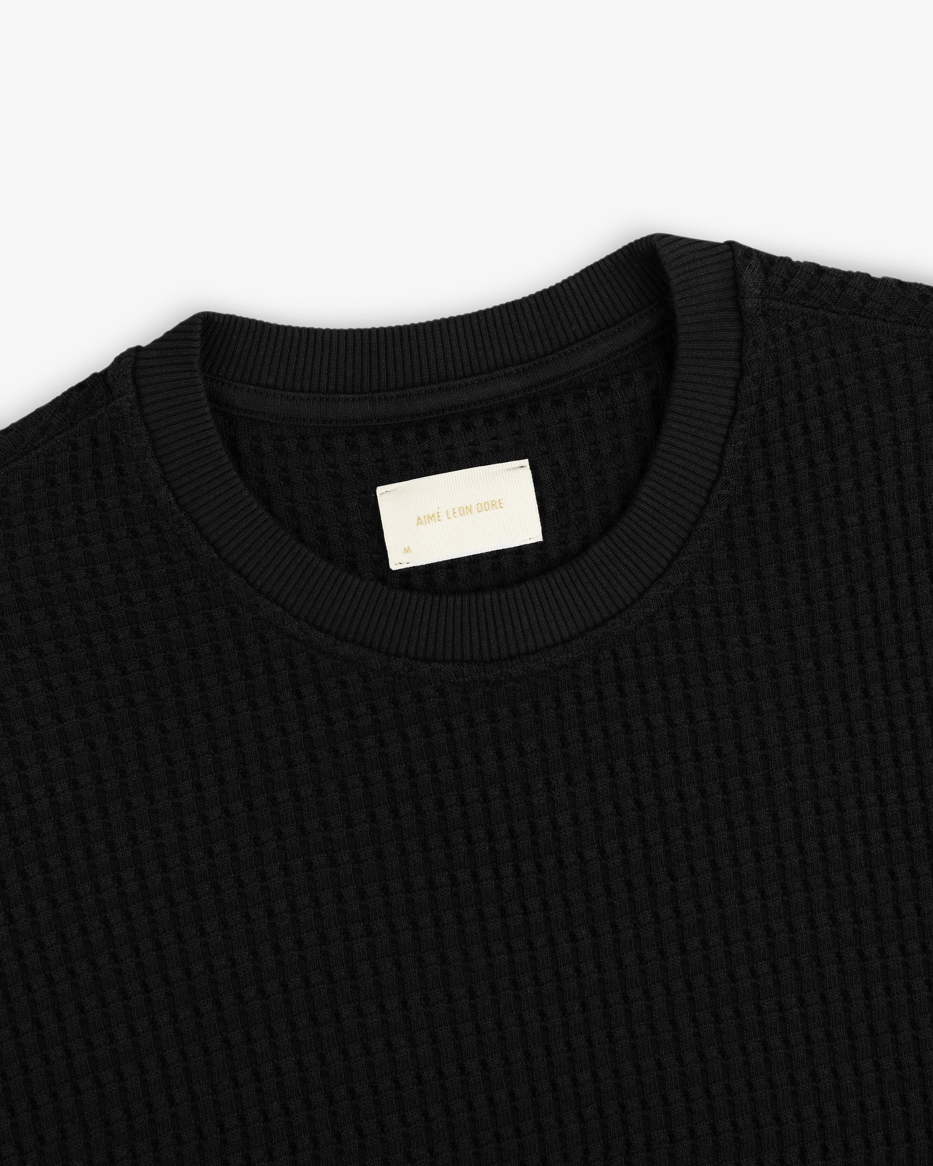 Black Long-Sleeve Waffle Thermal shirt with a ribbed crewneck collar and a branded inner neck label.
