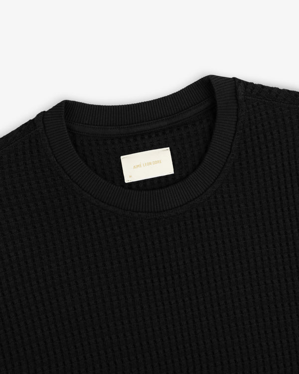 Black Long-Sleeve Waffle Thermal shirt with a ribbed crewneck collar and a branded inner neck label.