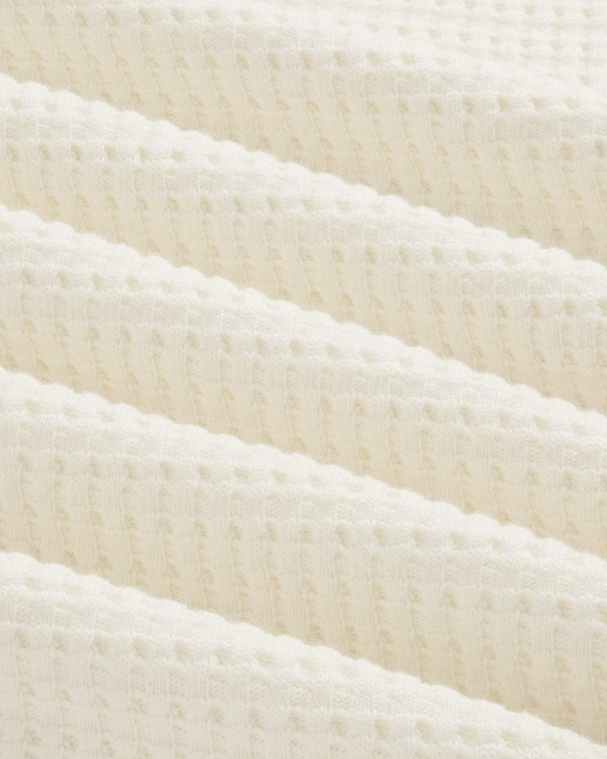 Off-white Long-Sleeve Waffle Thermal fabric with a textured waffle-knit pattern in diagonal folds.