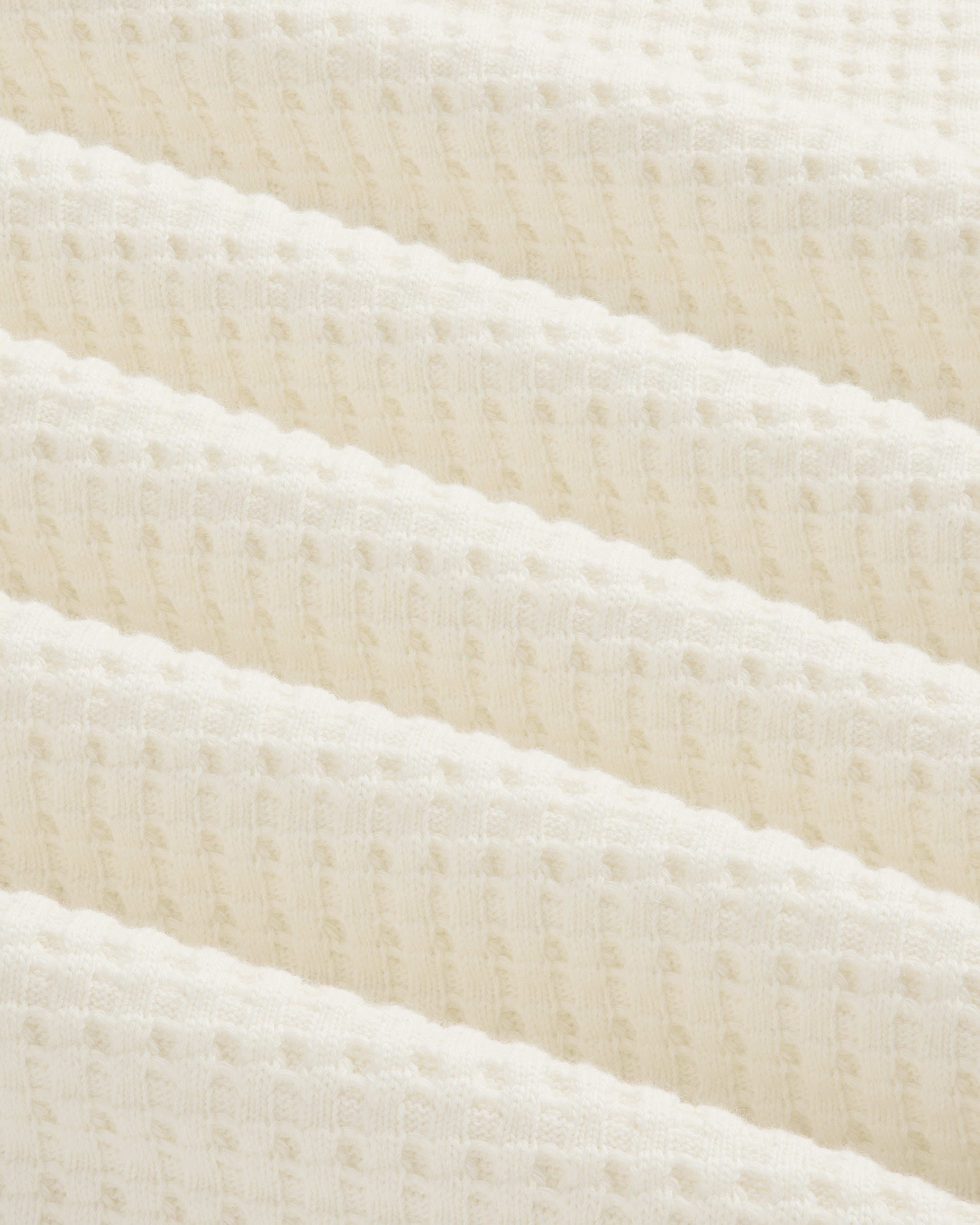 Off-white Long-Sleeve Waffle Thermal fabric with a textured waffle-knit pattern in diagonal folds.