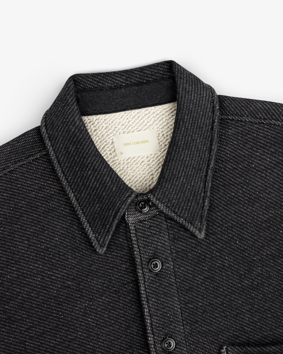 Terry Lounge Shirt: black collared button-down with textured cream-colored lining and a brand label at the neck.