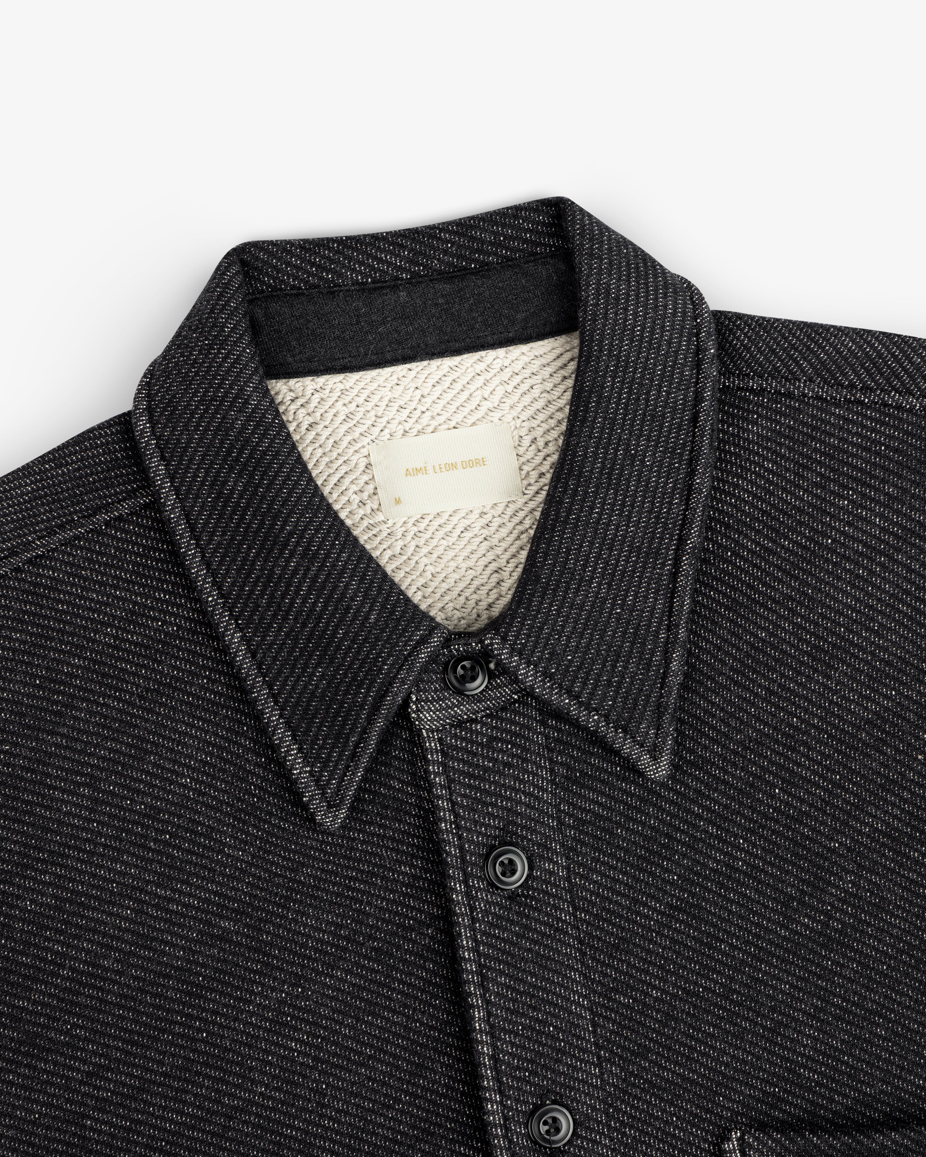 Terry Lounge Shirt: black collared button-down with textured cream-colored lining and a brand label at the neck.