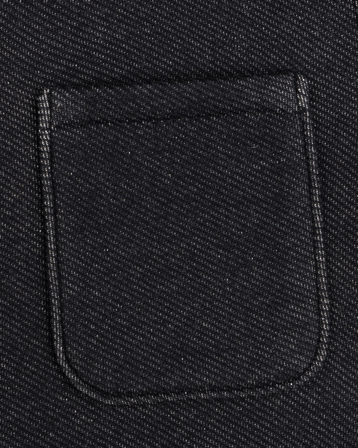 Close-up of a dark, textured Terry Lounge Shirt with a rectangular chest pocket.