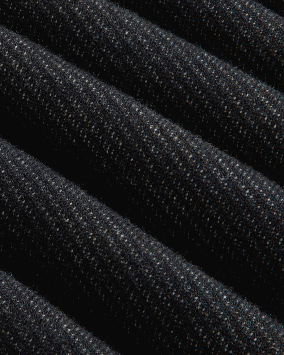 Close-up of the dark charcoal Terry Lounge Shirt, featuring folded fabric with a textured, flecked surface.