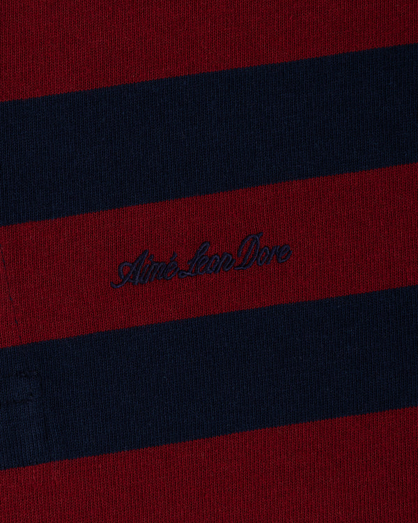 Striped Script Rugby in dark red and navy blue knit fabric with embroidered cursive text in the center.