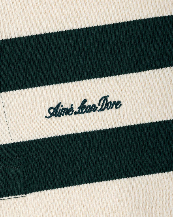 Striped Script Rugby in cream and dark green striped fabric with Aimé Leon Dore embroidered in dark green script.