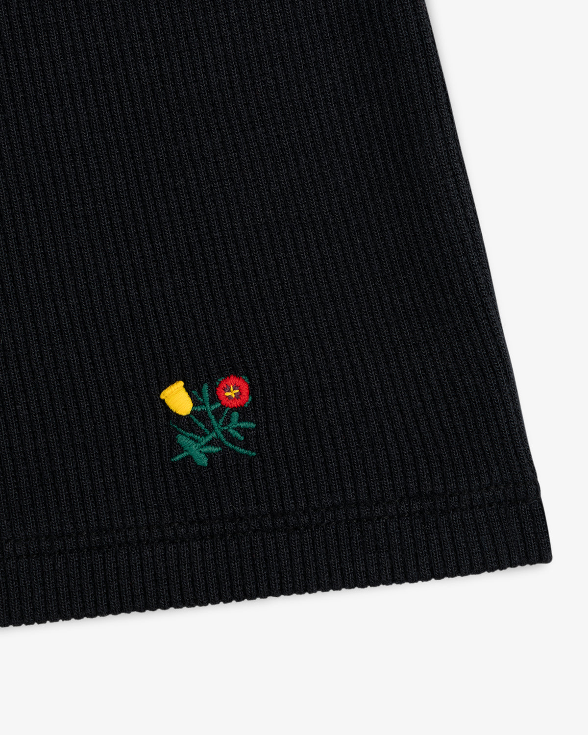 Black Ribbed Scoop Neck Long-Sleeve Tee with a small embroidered yellow and red flower near the hem.