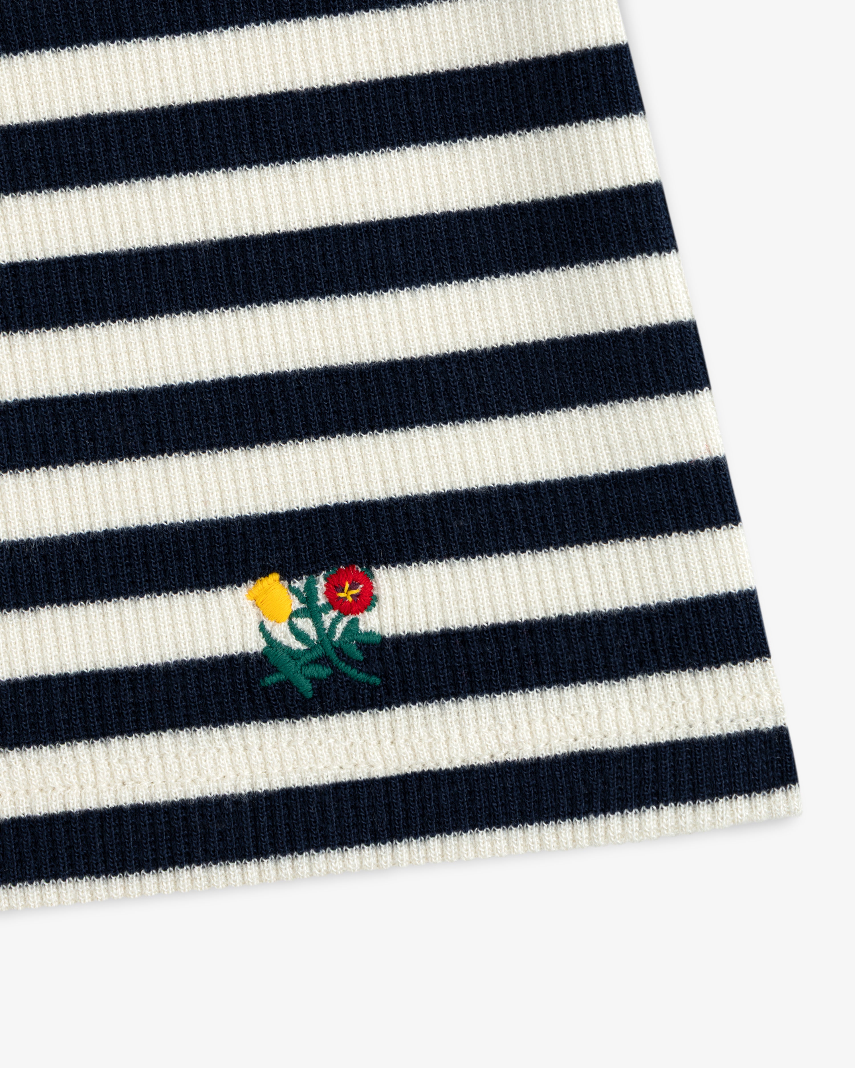 Ribbed Scoop Neck Long-Sleeve Tee in navy and white striped ribbed knit fabric with a small embroidered flower motif.