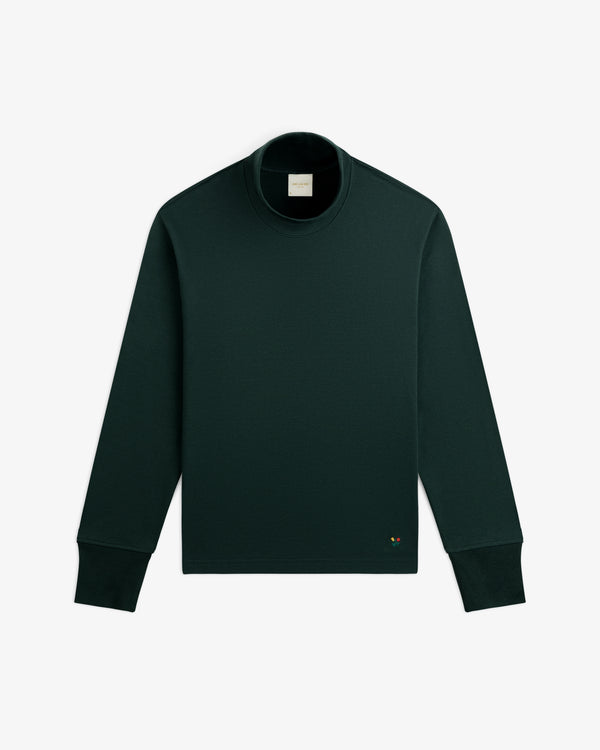 Heavyweight Crest Mockneck Tee in dark green with a small embroidered emblem on the lower front.