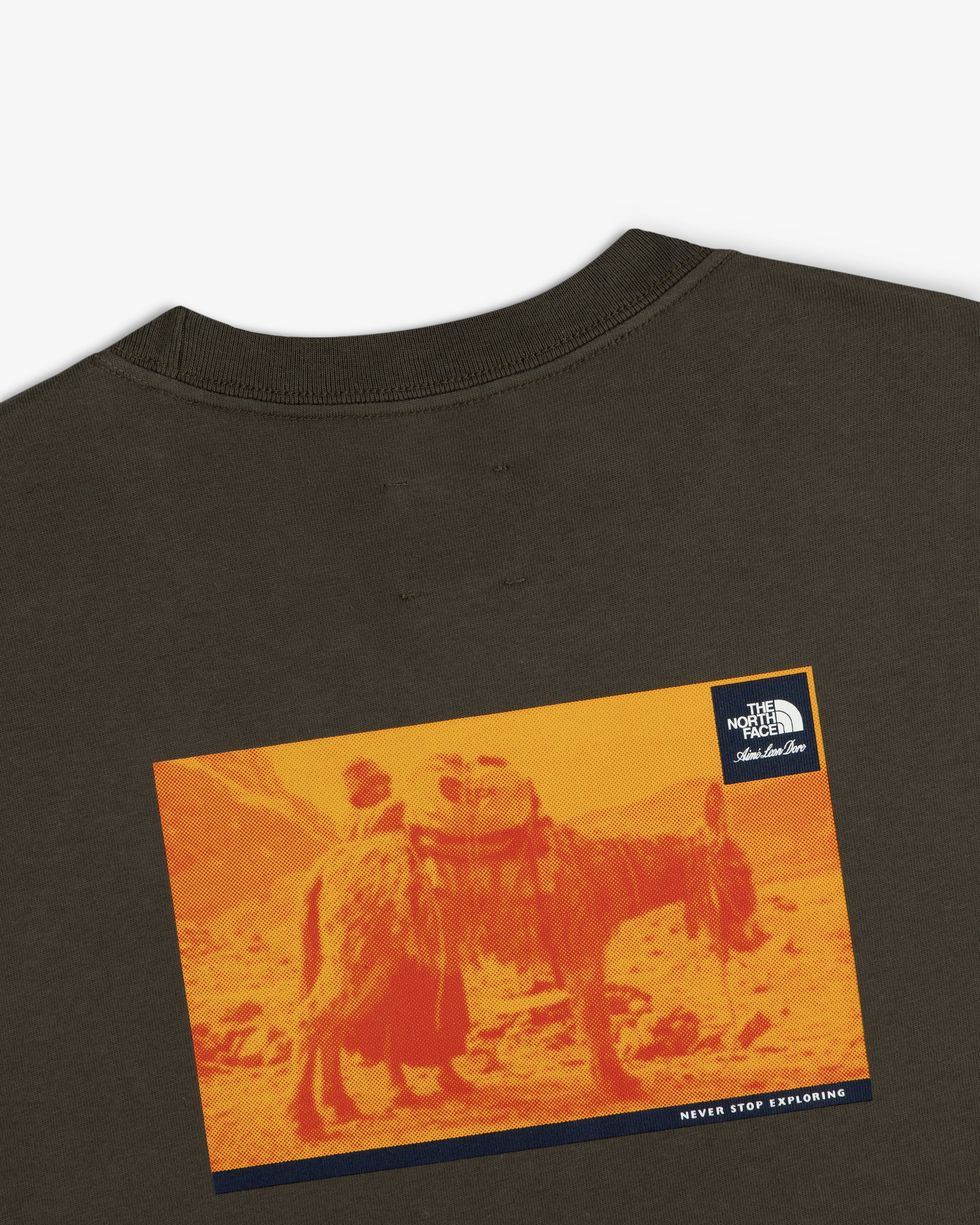 A graphic pack animal on orange landscape features on the ALD/The North Face Long-Sleeve Explorer Tee’s back.
