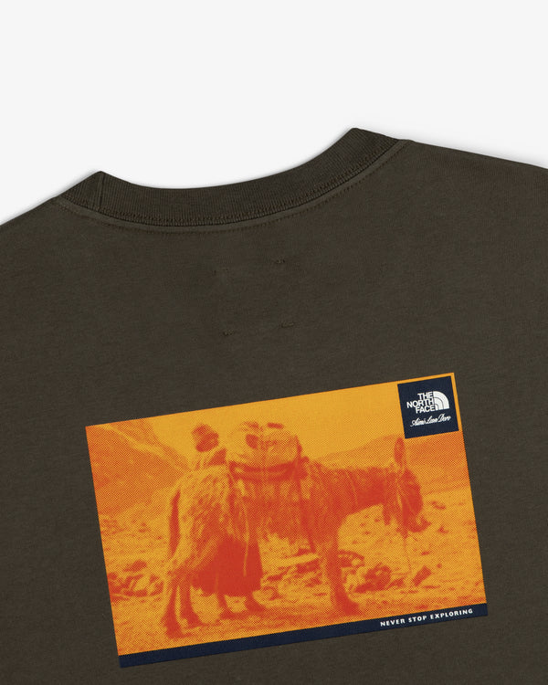 A graphic pack animal on orange landscape features on the ALD/The North Face Long-Sleeve Explorer Tee’s back.