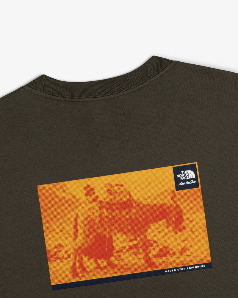 A graphic pack animal on orange landscape features on the ALD/The North Face Long-Sleeve Explorer Tee’s back.