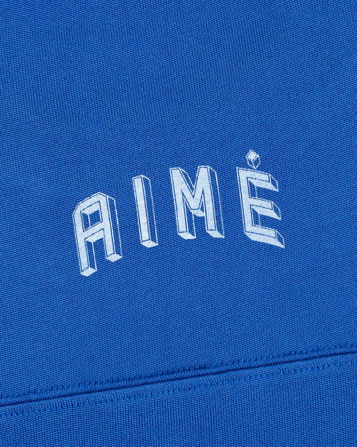 Blue Football Ringer Tee featuring the word AIMÉ in white outlined, block lettering.