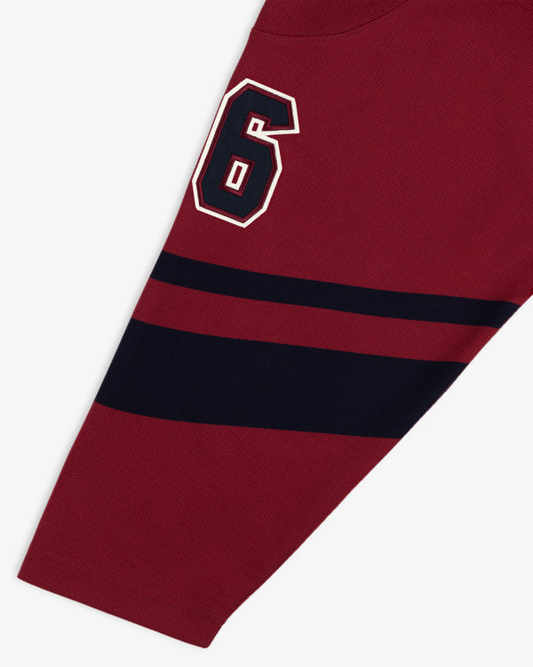 Team Aimé Hockey Jersey sleeve in maroon with a navy and white number 6 and two horizontal navy stripes.