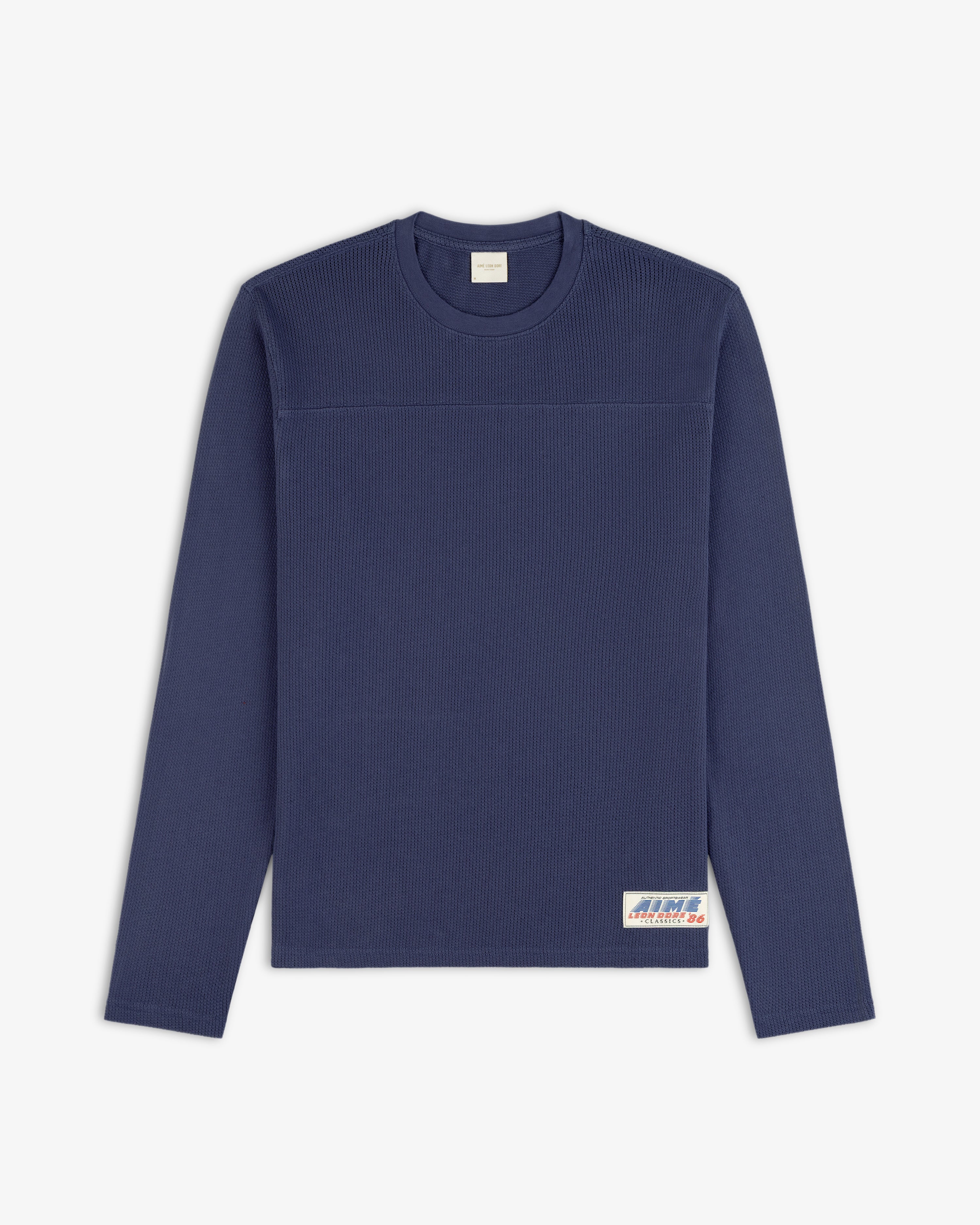 Navy blue Long-Sleeve Mesh Football Tee with ribbed texture and a small white label near the bottom hem.
