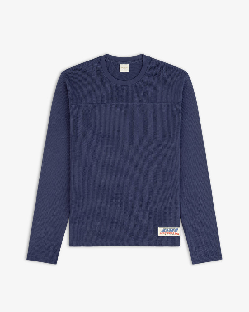 Navy blue Long-Sleeve Mesh Football Tee with ribbed texture and a small white label near the bottom hem.