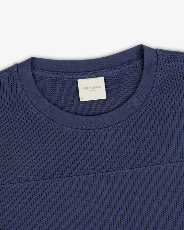 Navy blue Long-Sleeve Mesh Football Tee with visible Aimé Leon Dore collar label, on a white background.