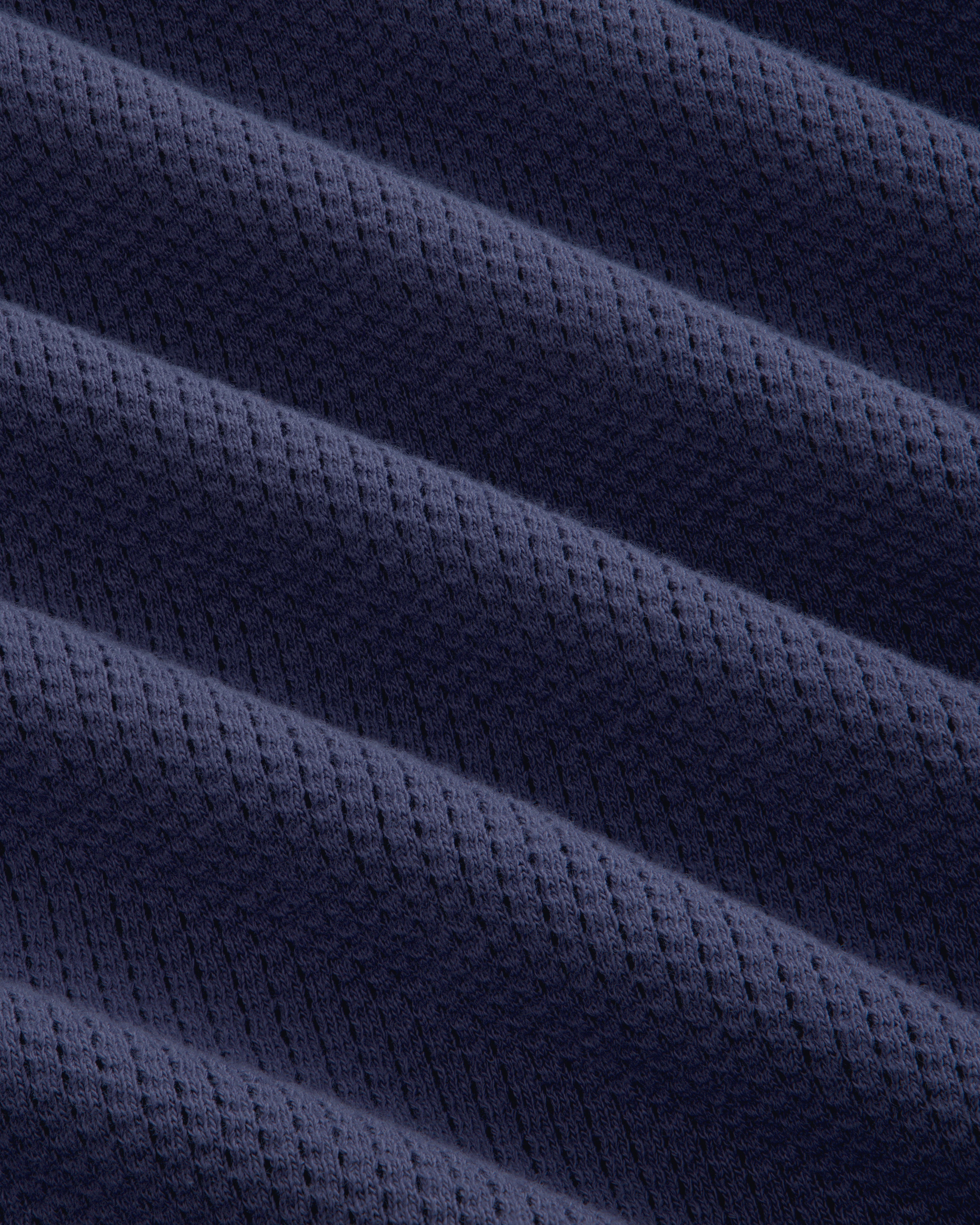 Close-up of Long-Sleeve Mesh Football Tee in dark blue, featuring diagonal ridges and a dotted texture.