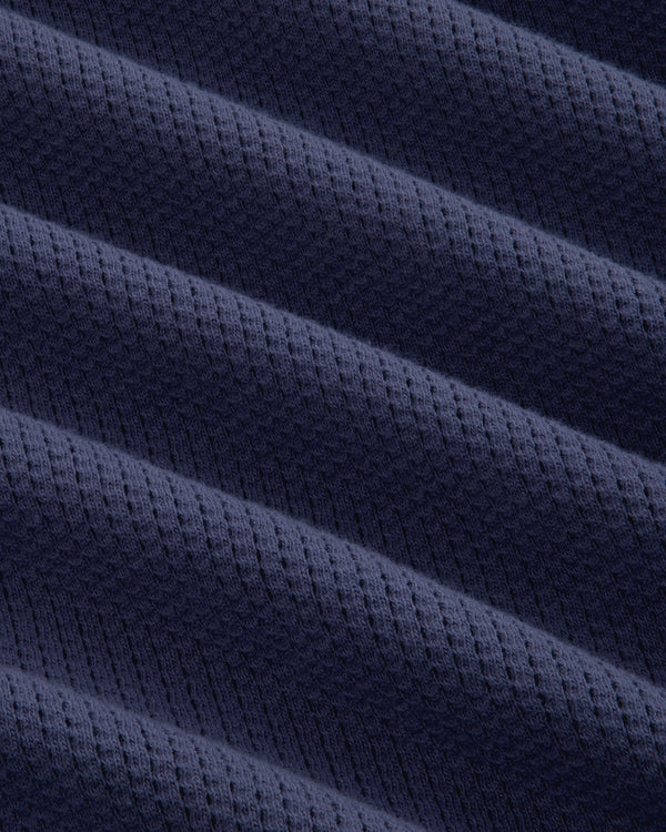 Close-up of Long-Sleeve Mesh Football Tee in dark blue, featuring diagonal ridges and a dotted texture.