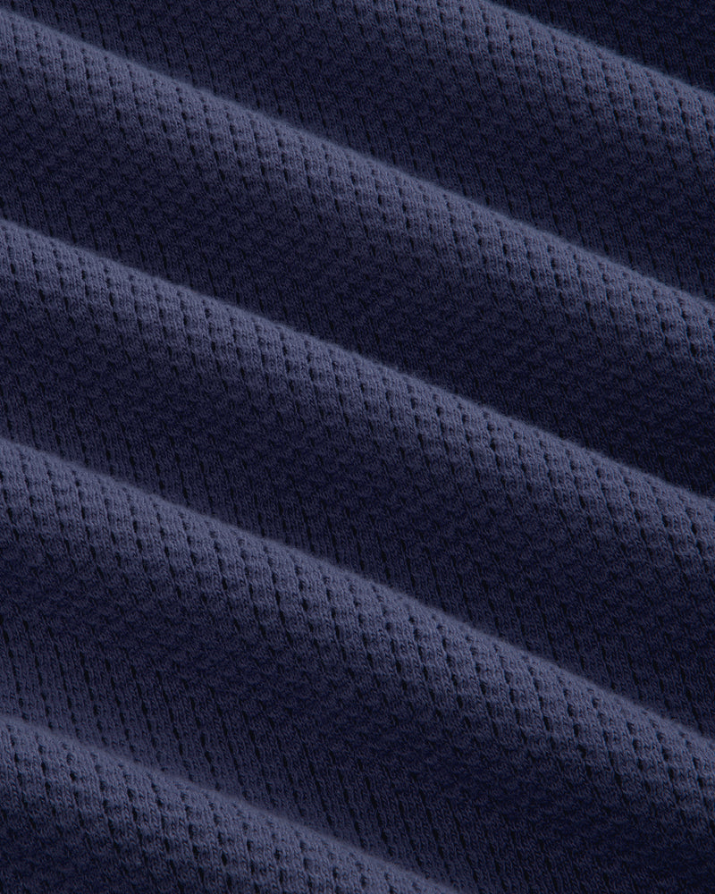 Close-up of Long-Sleeve Mesh Football Tee in dark blue, featuring diagonal ridges and a dotted texture.